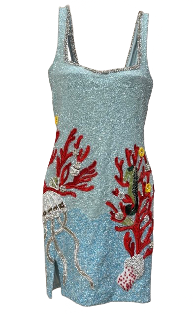 A light blue sequined mini dress featuring red coral and jellyfish embellishments on the front, set against a plain white background.